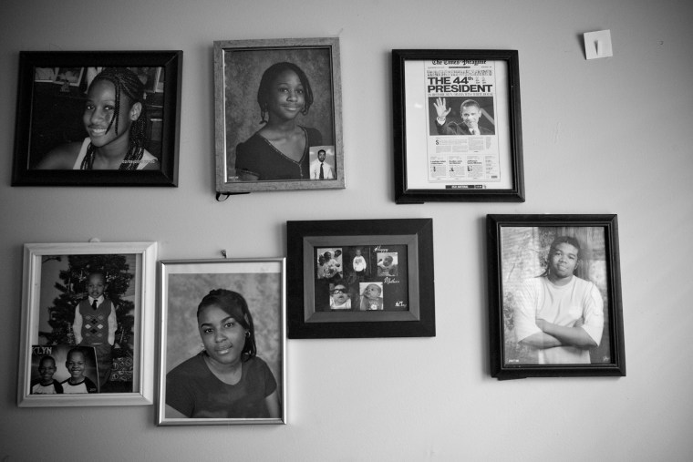 Family photos hang on a wall in the Perteet home in Chicago.