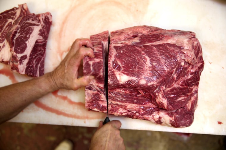 A butcher prepares cuts of beef at on January 13, 2014 in North Miami Beach, Florida.