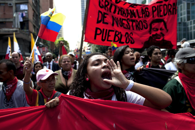 Members of a pro-government \"colectivo,\" or \"collective,\" march in downtown Caracas, Venezuela, on  Feb. 20, 2014.