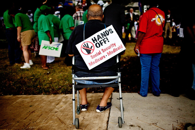 A protester listens at the rally outside the Social Security Administration offices in Baltimore, Maryland, July 25, 2011.