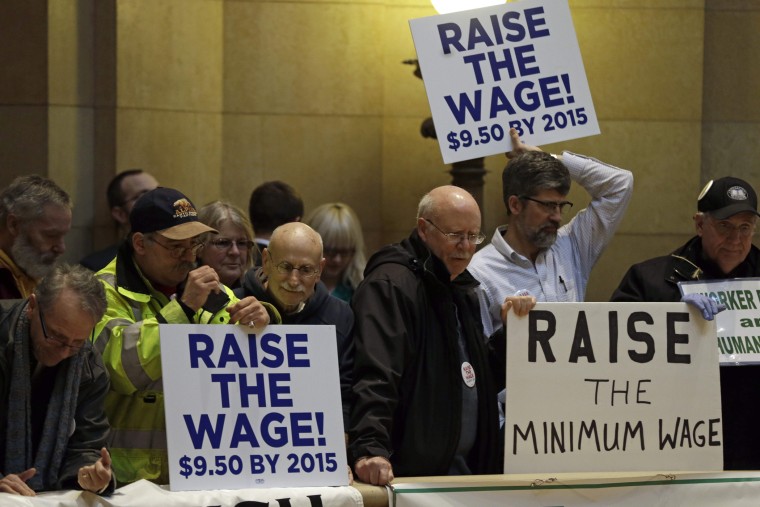 Demonstrators rally at the state Capitol, calling for lawmakers to raise the minimum wage, February 25, 2014, in St. Paul, Minn.