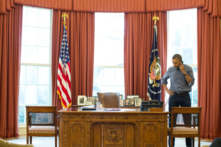 President Barack Obama talks on the phone in the Oval Office with Russian President Vladimir Putin about the situation in Ukraine, March 1, 2014.