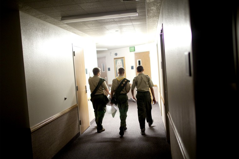 Boy scouts walk through the empty halls of a meeting house of the Church of Jesus Christ of Latter-day Saints, in Cedar Hills, Utah, Oct. 11, 2012.