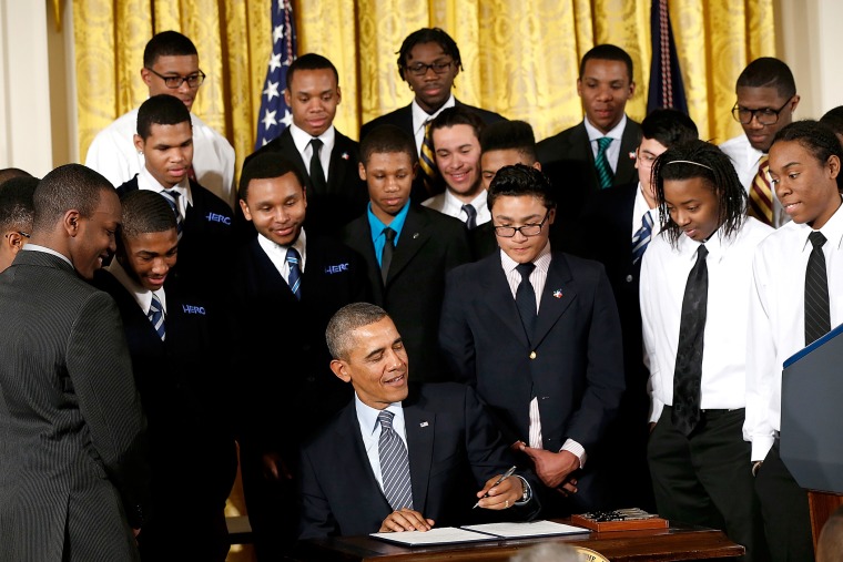 U.S. President Barack Obama signs an executive memorandum regarding the My Brother's Keeper initiative, Feb. 27, 2014.