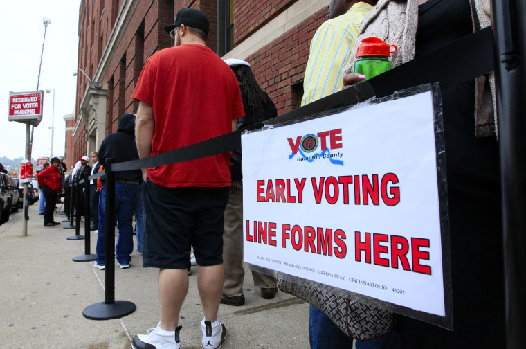 FILE - In this Oct. 2, 2012, file photo, voters stand in line outside the Hamilton County Board of Elections just before it opened for early voting, in...