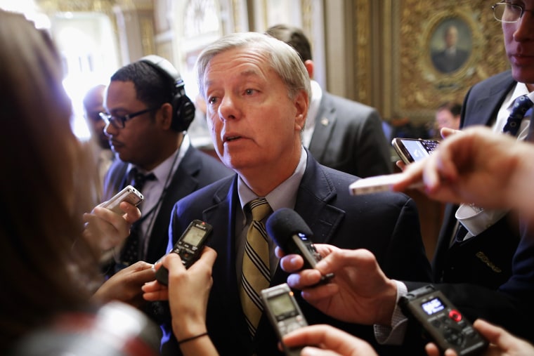 Sen. Lindsey Graham talks with reporters after stepping off the Senate floor at the U.S. Capitol, Nov. 21, 2013.