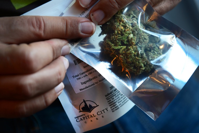 A man purchases medical marijuana at Capital City Care in Washington, DC, July 29, 2013.