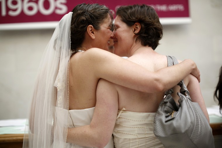 Same-sex couple Cynthia Wides (L) and Elizabeth Carey embrace each other as they turn in their marriage license at City Hall in San Francisco, on June 29, 2013.