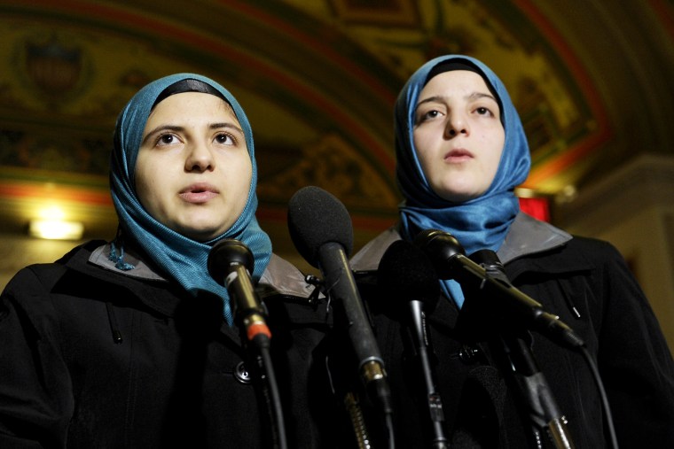 Heba Sawwan, left, and her cousin Ameenah Sawwan, right, survivors of the August 2013 chemical weapons attack in Syria, speak during a news conference in Washington, Feb. 6, 2014.