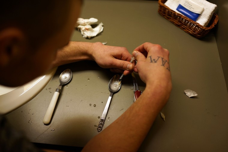 Drugs are prepared to shoot intravenously by a user addicted to heroin, February 6, 2014.