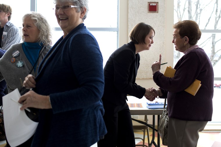 Shenna Bellows speaks with Shirley Rosen in the East End School cafeteria in Portland, Maine, on March 3, 2014.