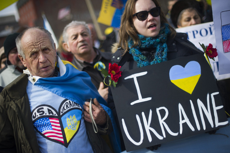 Demonstrators stand with placards and chant during a rally against Russian aggression in the Ukraine in front of the White House in Washington, D.C., March 6, 2014.