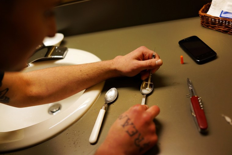 Drugs are prepared to shoot intravenously by a user addicted to heroin in Vermont, Feb. 6, 2014.