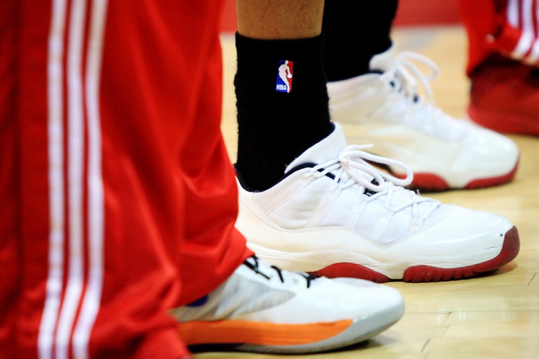 NBA logo is displayed on a pair of socks during a game.