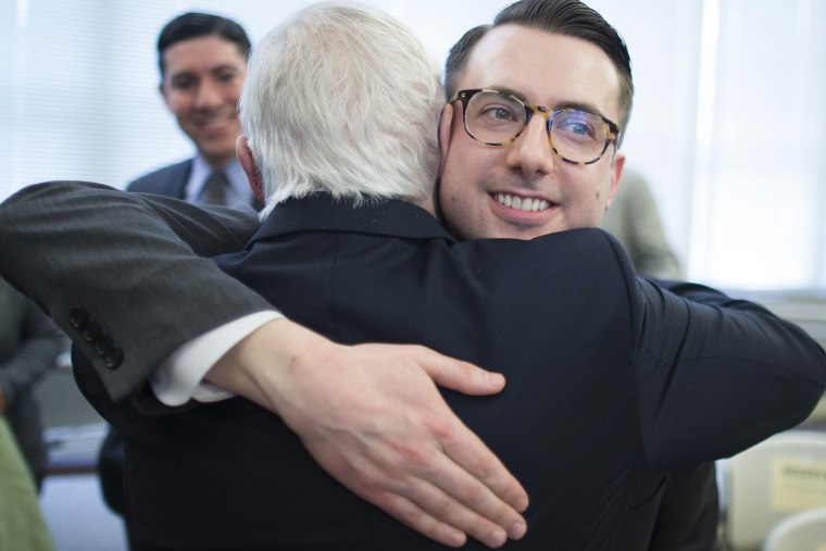 Thomas Rimbey Ogletree, center right, hugs his father, the Rev. Thomas Ogletree on March 10, 2014 in White Plains, N.Y.