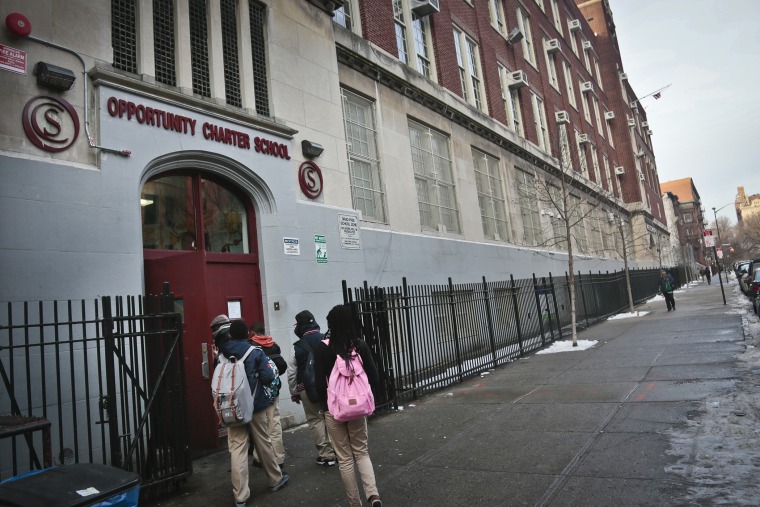 Students use the entrance for Success Academy and Opportunity Charity schools, both of which share space inside Harlem's P.S. 241, in New York on Dec. 20, 2013.