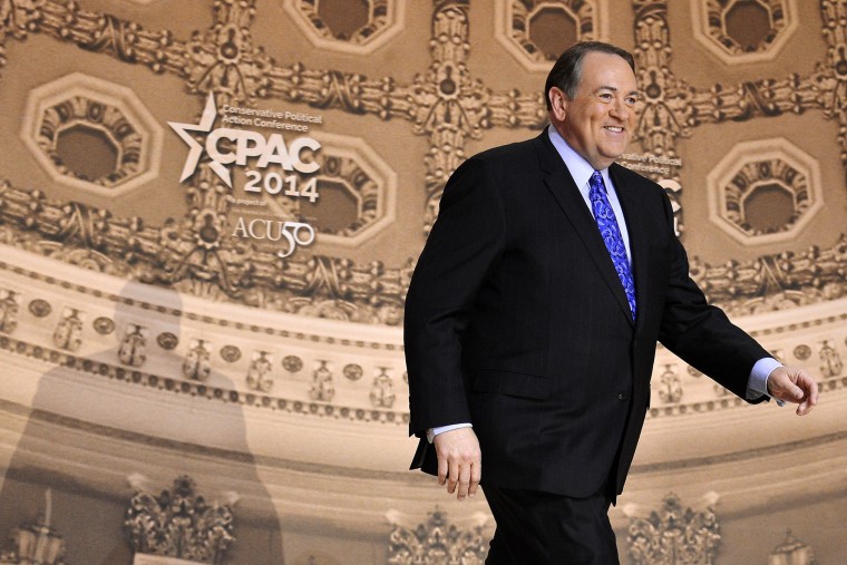 Former Arkansas Governor Mike Huckabee arrives onstage to make remarks at CPAC, Mar. 7, 2014.