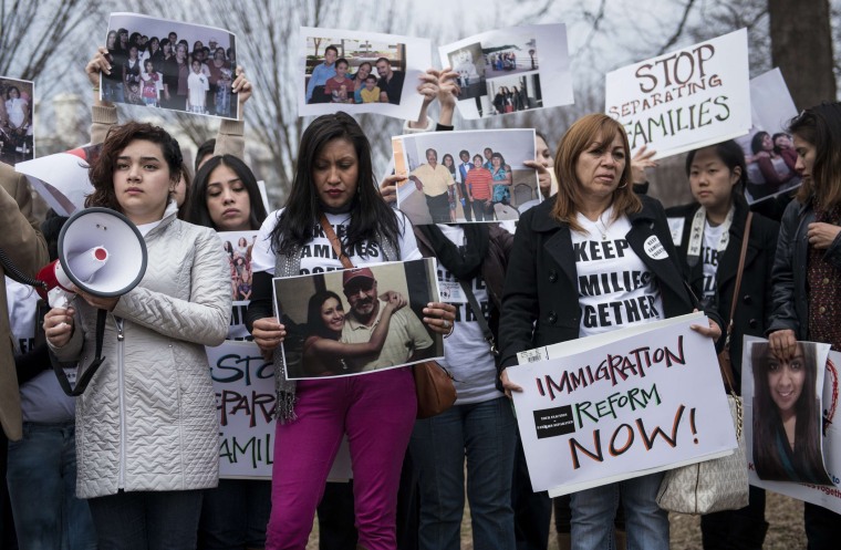 Activists hold signs and family photos in Lafayette Square outside the White House March 12, 2014 in Washington, D.C.