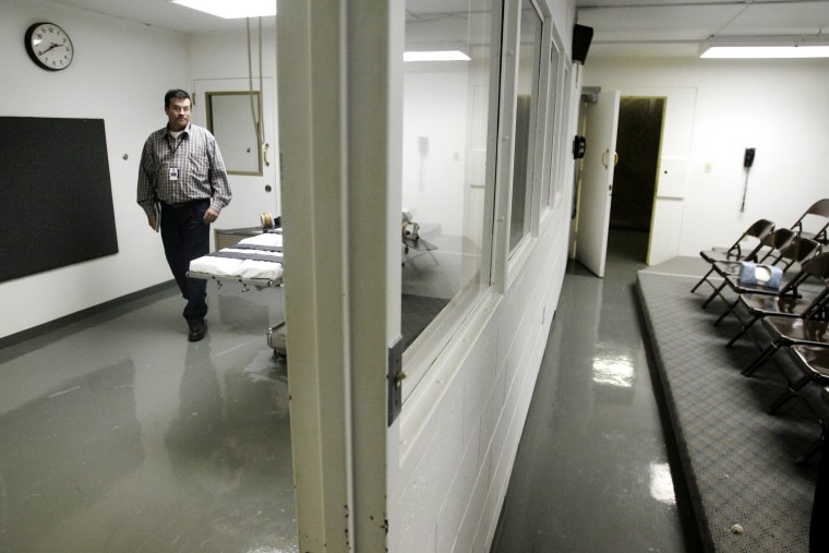 In this April 15, 2008, file photo a wardens assistant at the Oklahoma State Penitentiary, walks past the gurney in the execution chamber at left, in McAlester, Okla..