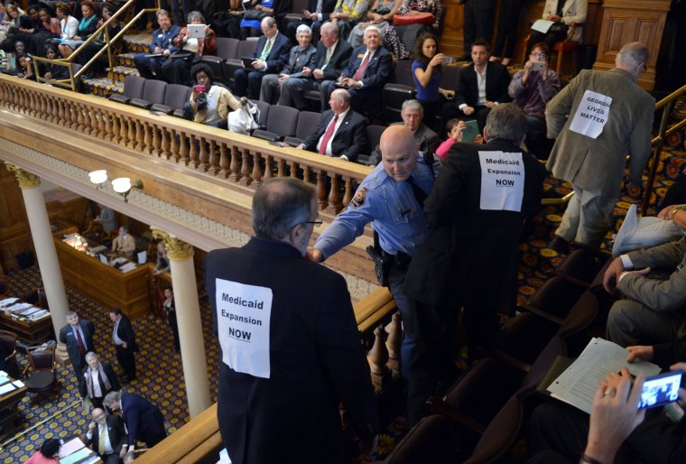 About 20 protestors are arrested at the Georgia state Capitol after disrupting the Senate, Tuesday, March 18, 2014.