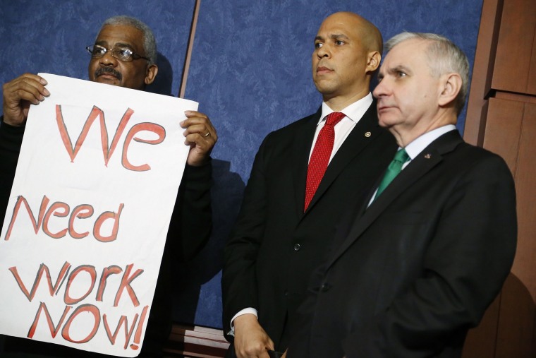 U.S. Senator Cory Booker (D-NJ) and Senator Jack Reed (D-RI) (R) hold a news conference with unemployed Americans, at the U.S. Capitol in Washington, January 16, 2014.