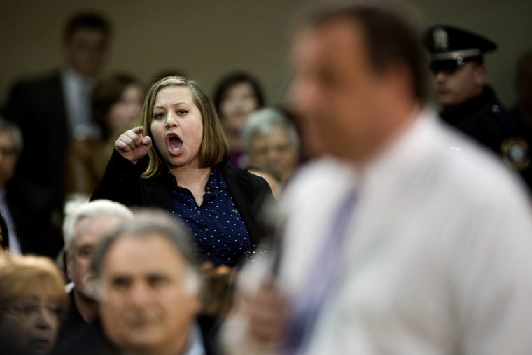 An audience member shouts at New Jersey Gov. Chris Christie during a town hall meeting, on March 13, 2014, in Mount Laurel, N.J.