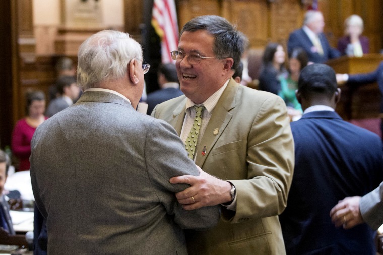 Georgia Rep. Rick Jasperse, R-Jasper, facing, celebrates with Rep. Wendell Willard, R-Sandy Springs, after a gun bill passed in the House Chambers on the last day of the legislative session at the Georgia State Capitol, on March 20, 2014, in Atlanta.