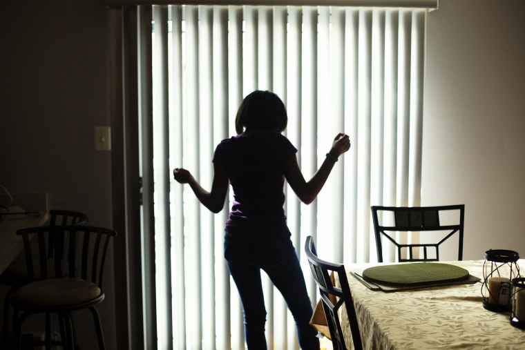 Denaisha Hyson, 12, dances in her home where she lives with her mother.