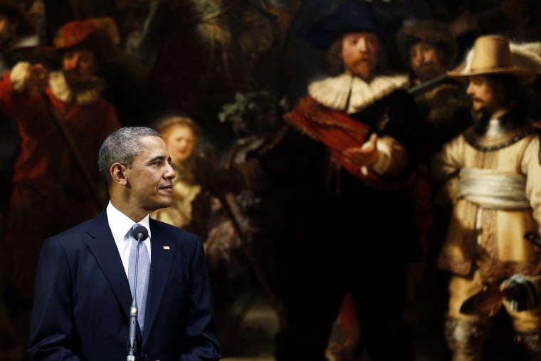 President Barack Obama looks over at the Dutch Prime Minister during a joint press conference held in front of Rembrandt's painting \"The Night Watch\"
