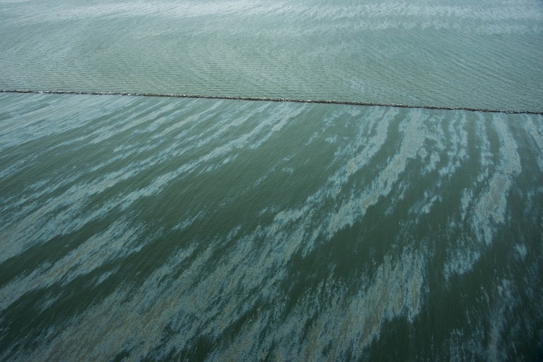 A sheen is seen on the water near East Beach and the Galveston Jetties on March 23, 2014, in Galveston, Texas.