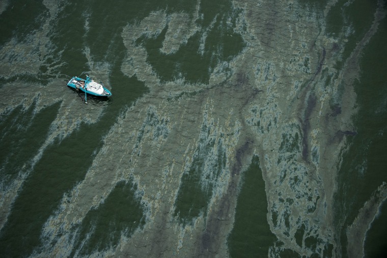 A vessel surrounded by a sheen on the water near the Port of Galveston on March 23, 2014, in Galveston, Texas.