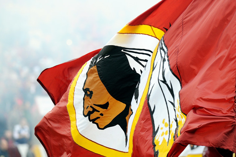A Redskins flag is displayed before the game between the Dallas Cowboys and the Washington Redskins, Dec. 22, 2013.