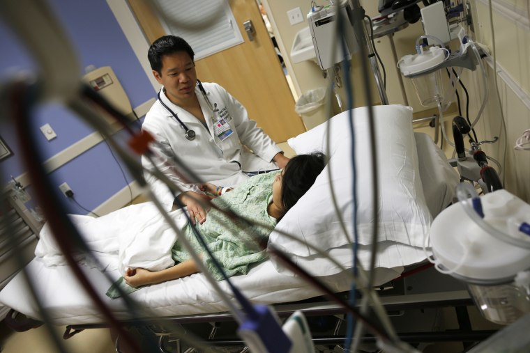 A patient speaks with Doctor Leon Yeh in the Emergency Room at OSF Saint Francis Medical Center in Peoria, Illinois, Nov. 26, 2013.