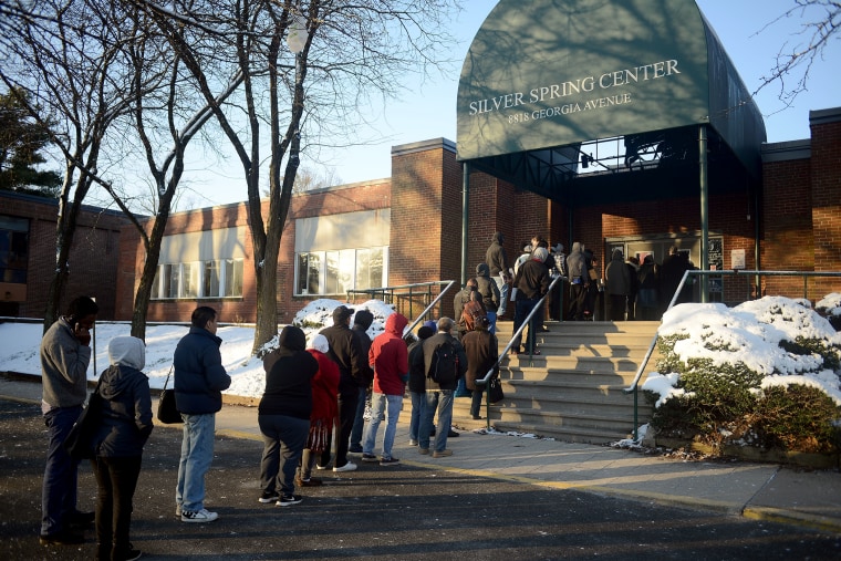 Dozens of uninsured residents of Montgomery County stand in line at the Department of Health and Human Services of the Silver Spring Center to sign up for insurance on March 26, 2014.