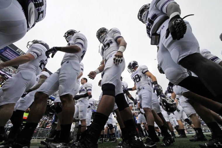 The Northwestern football team heads to the locker room after warming up before an NCAA college football game against Penn State in State College, Pa, Oct. 6, 2012.