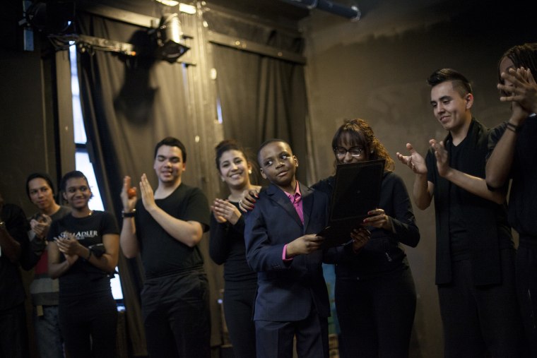 Kwasy Ahama is congratulated by Stella Adler Studio actors after receiving the award for Middle School Playwright of the Year from the Stella Adler Studio for Acting.