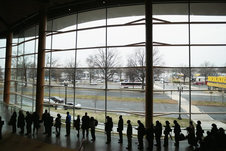 About 1,500 people seeking employment wait in line to enter a job fair at the Arena Stage at the Mead Center for American Theater, March 28, 2014 in Washington, D.C.