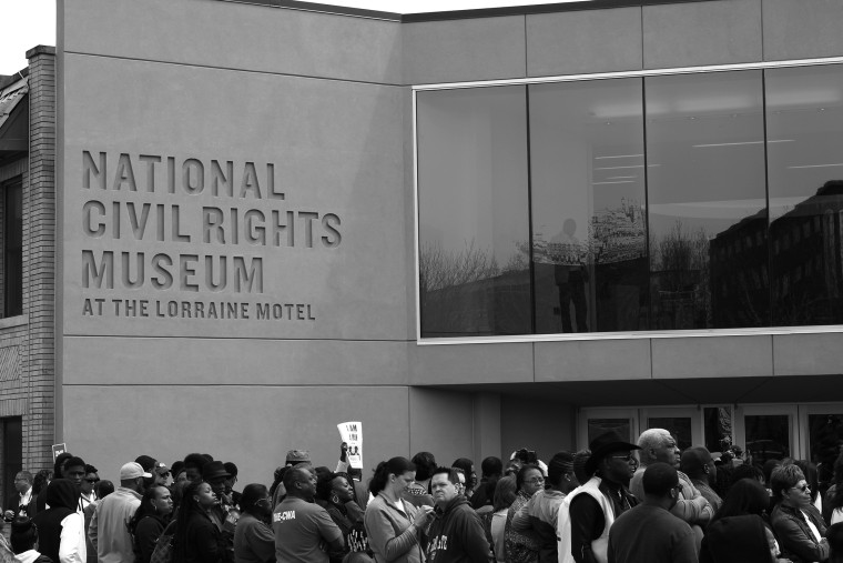 Visitors gather and listen as speakers mark the reopening of the National Civil Rights Museum, April 5, 2014, in Memphis, Tenn.