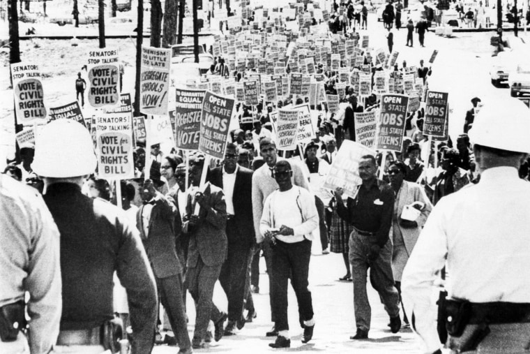 Marchers near the Florida State Capitol carrying signs urging passage of the Civil Rights in Congress on March 27, 1964 in Tallahassee, Fla.