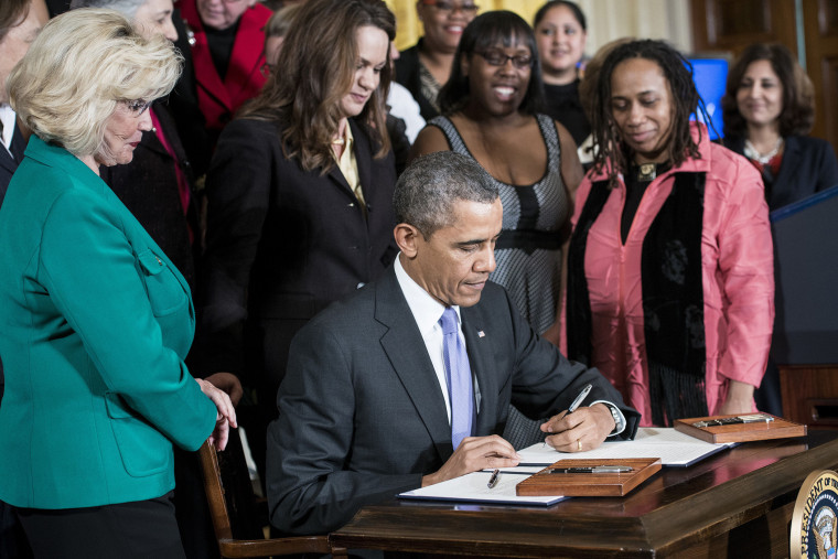 US President Barack Obama signs an executive order during an event in the East Room of the White House April 8, 2014 in Washington, DC.
