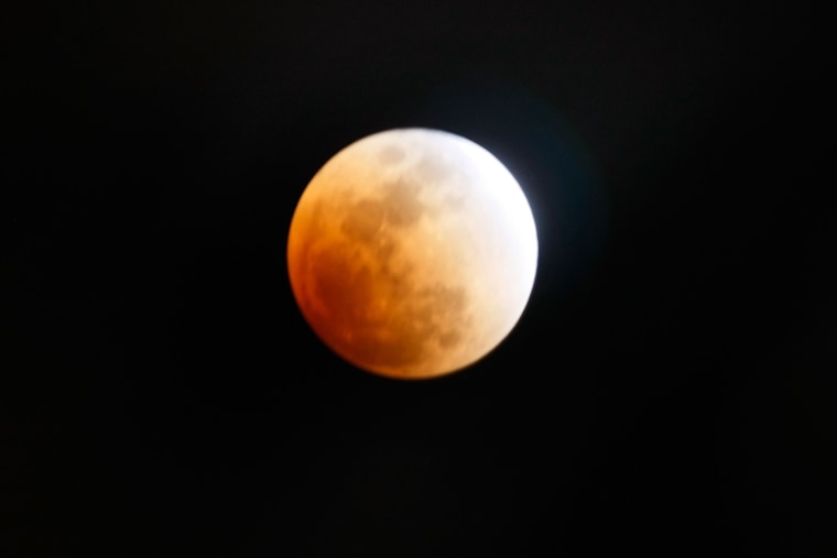 The moon is partly covered in the Earth's shadow during a phase of the lunar eclipse on Feb. 20, 2008 in Miami, Florida.