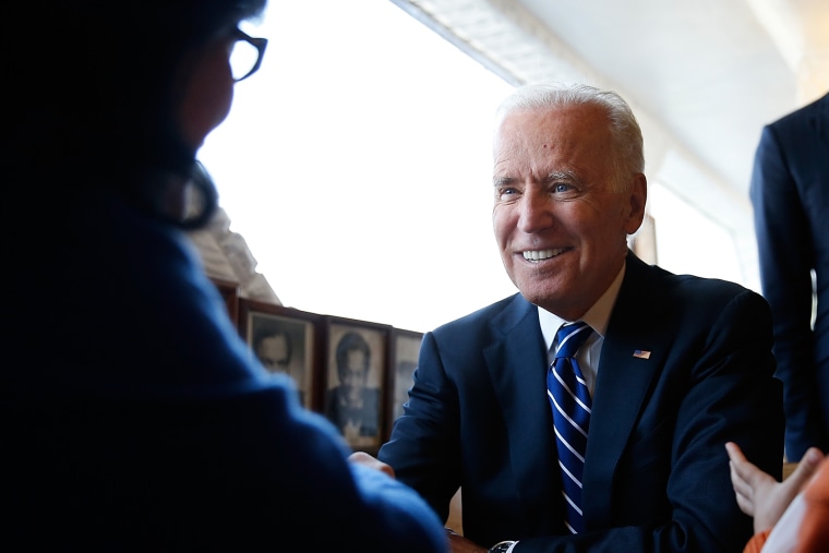 U.S. Vice President Joe Biden sits with customers while visiting the Florida Avenue Grill March 26, 2014 in Washington, DC.