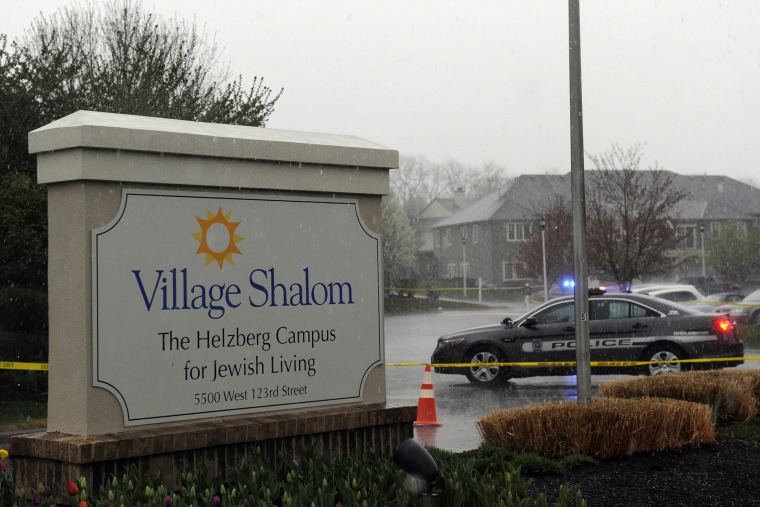 A police car blocks the scene of a shooting at Village Shalom, an assisted living center, as rain falls in Overland Park, Kansas April 13, 2014.