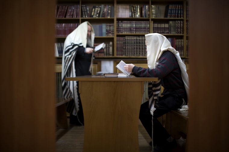 Two Jewish men read prayers in a synagogue in Donetsk, Ukraine, on April 18, 2014.