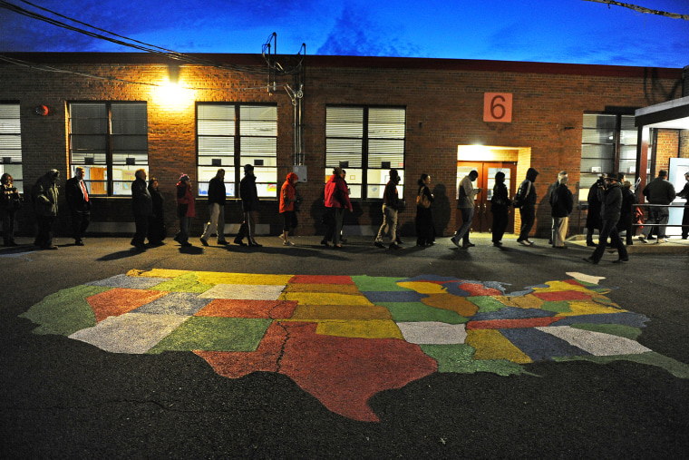 People enter Washington Mill Elementary School to cast their vote in the U.S. presidential race, Nov. 6, 2012, in Alexandria, Va.