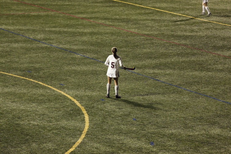 Woman playing field hockey.