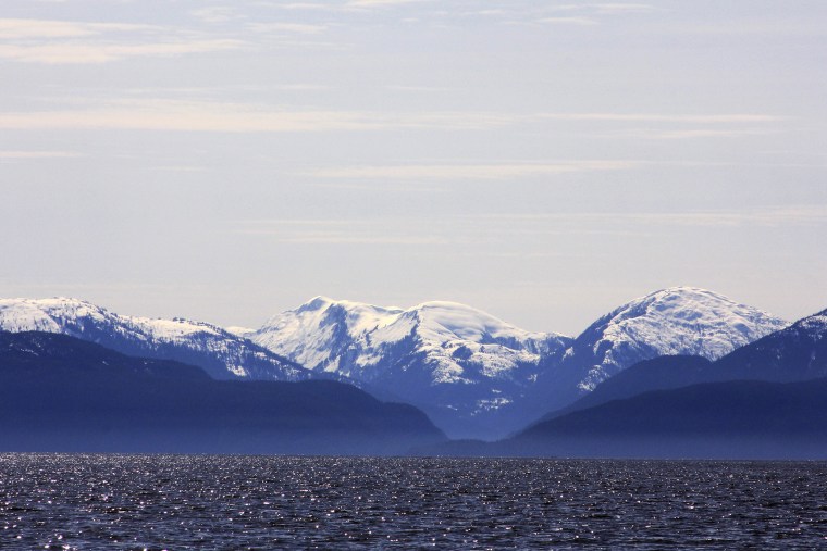Snow-capped mountains peak out over a cove area favored by fishermen in the Douglas Channel, in northern British Columbia near to where Enbridge Inc plans to build its Northern Gateway pipeline terminal facility April 13, 2014.
