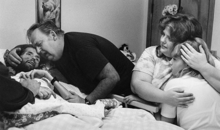 David Kirby, an HIV/AIDS activist, near death, surrounded by his family in Ohio, 1990.