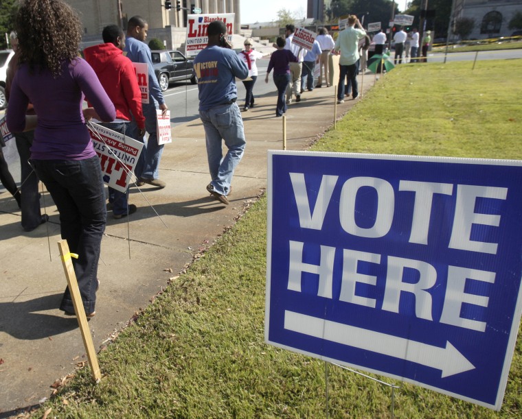 Campaign workers and volunteers walks past an early voting polling place in Little Rock, Ark., Monday, Oct. 18, 2010.