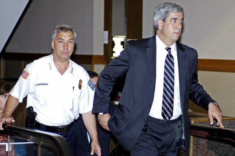 Buffalo Police Commissioner Daniel Derenda, left, and Erie County District Attorney Frank Sedita travel the escalator to the courtroom for proceedings in Buffalo, N.Y., 2010.